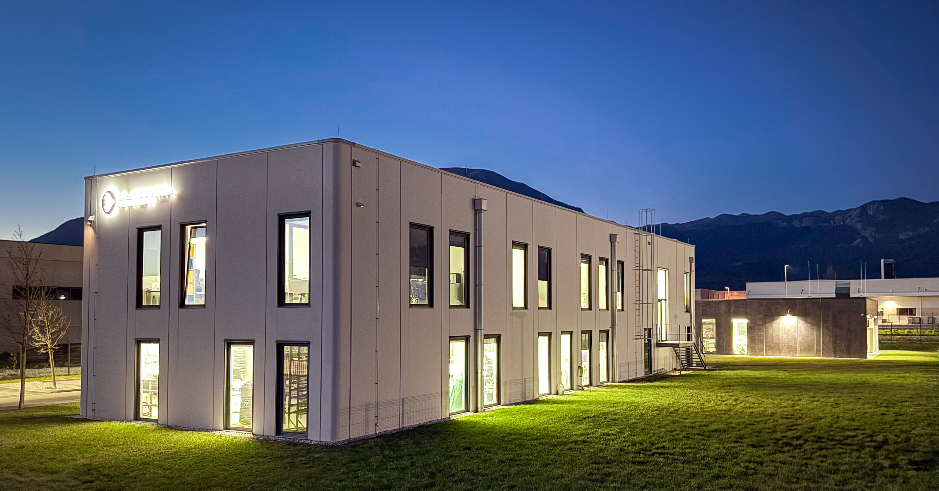 C-Astral production facility exterior at dusk